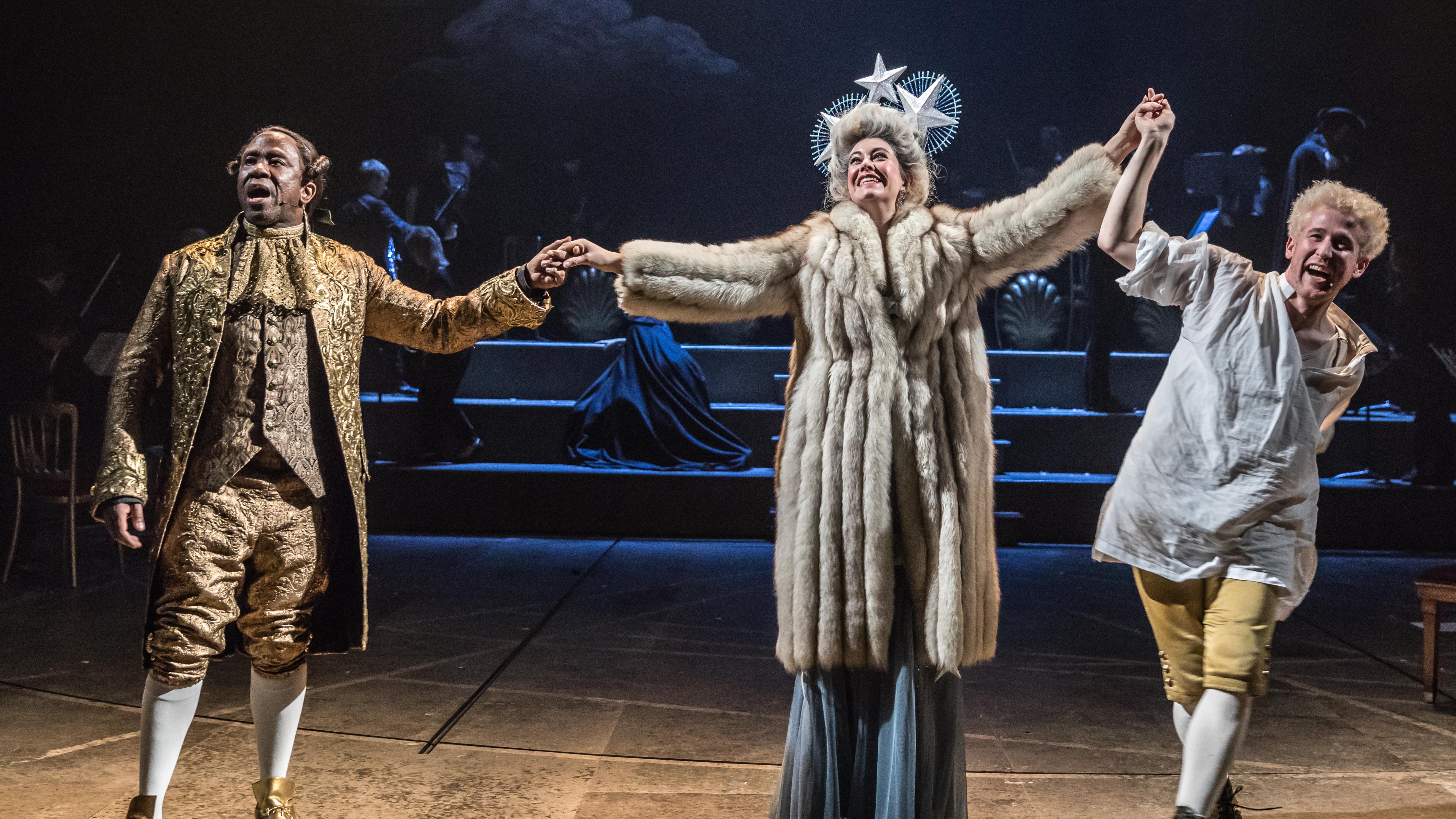 Lucian Msamati, Fleur de Bray, and Adam Gillen in the National Theatre's production of "Amadeus" by Peter Shaffer.