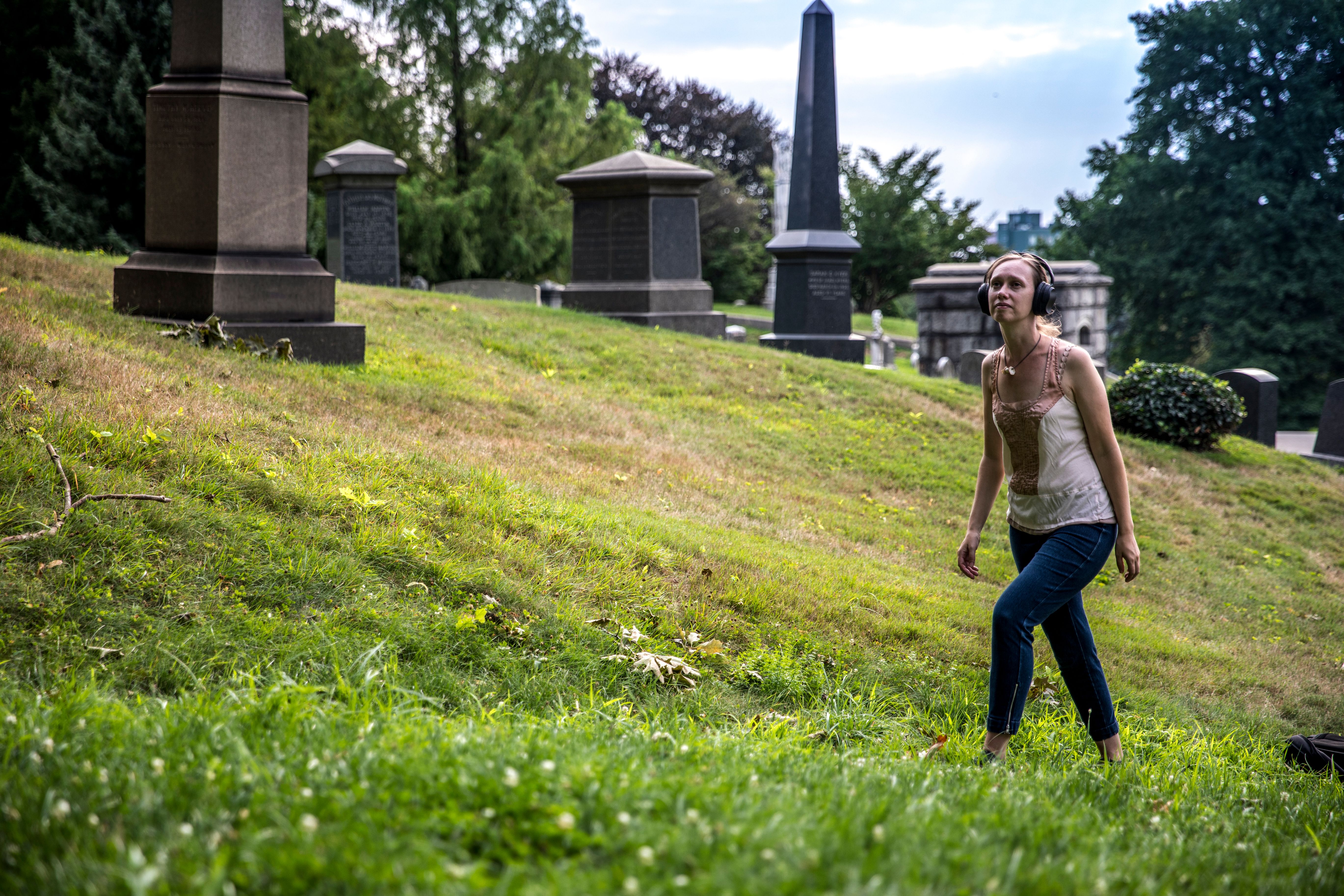 Gelsey Bell explores Green-Wood Cemetery in "Cairns". Photo by Maria Baranova.